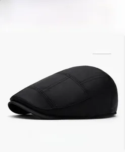 Detail of black newsboy hat featuring quilted fabric and a refined short brim design