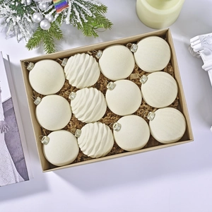 Set of 12 white Christmas velvet ornaments in two textures shown in a premium gift box