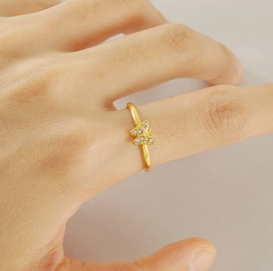 Detail of 18K gold-plated butterfly ring featuring sparkling micro-pave cubic zirconia
