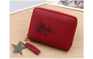 Close-up of red PU leather mini purse featuring a tassel, star pendant, and quote print