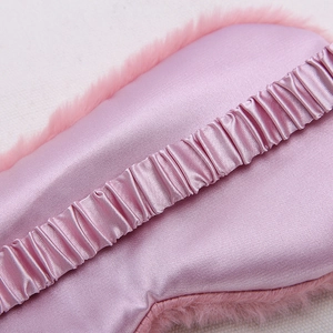 Pink silk sleeping eye mask with plush faux fur trim and elastic strap for comfort