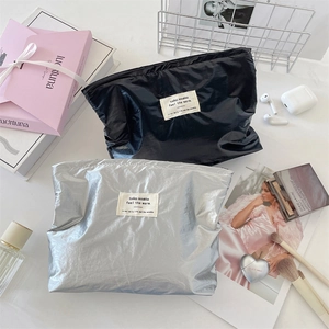 Chic silver and black metallic cosmetic bags displayed with luxury makeup accessories
