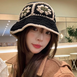 Handmade crochet bucket hat for women with floral patterns in black and beige yarn