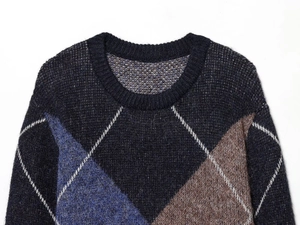 Close-up detail of argyle pattern knit sweater with soft brushed texture and crew neck