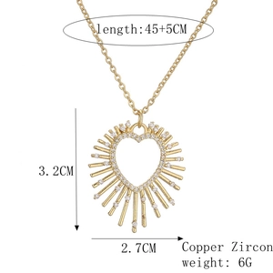 Detail view of gold heart pendant with white zircon showing dimensions 3.2cm by 2.7cm