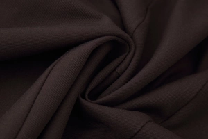 Detailed macro view of dark brown twill fabric texture with soft draped folds