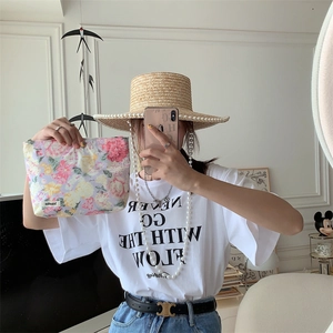 Floral cotton makeup bag shown in a lifestyle mirror selfie for a stylish portable look