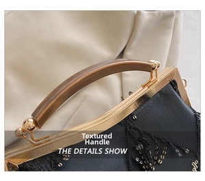 Close-up of black sequin evening bag with gold metal frame and amber resin handle