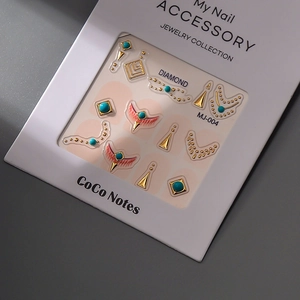 Detailed macro of vintage turquoise nail art charms with golden diamond shape accents