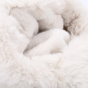 Close-up of soft fluffy faux fur texture in creamy white for winter trapper hat details