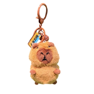 Cute brown plush capybara keychain with yellow tag and plastic lobster clasp hook