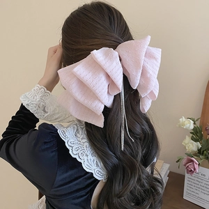 Pink textured lace bow hair clip with sparkling rhinestone tassels for elegant women