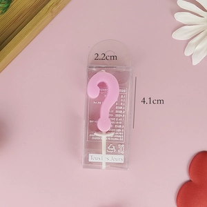 Detailed view of a pink question mark birthday candle in packaging with 2.2x4.1cm dimensions