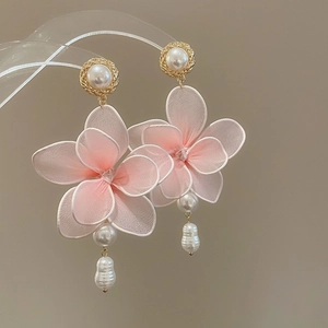 Detail of pink fabric flower earrings with baroque pearls and gold-plated accents
