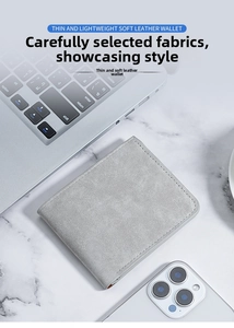 Slim light gray matte leather wallet for men on marble desk with modern devices