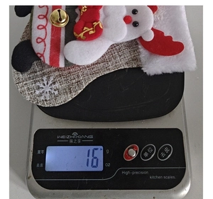 Detail of a 16g lightweight Christmas plush stocking featuring Santa Claus and bells