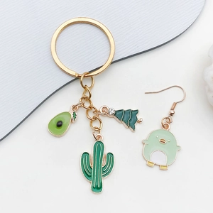 Porte-clés fleurs de cerisier émail vert et boucles d'oreilles oiseaux en alliage doré