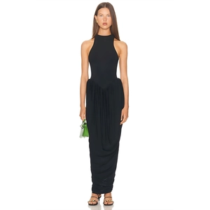Detail of the elegant ruched waist and irregular draping hem on this black maxi dress
