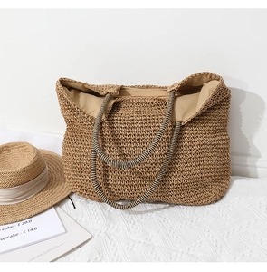 Macro detail of hand-woven straw tote bag with striped handles and inner fabric lining