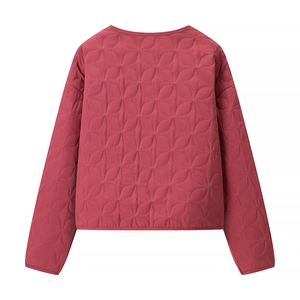 Detail of dark rose quilted jacket featuring unique floral geometric stitching patterns