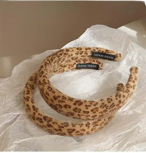 Detailed view of handmade plush leopard print headbands with soft faux fur texture