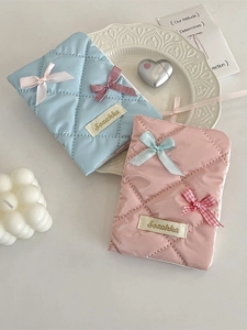 Quilted bow passport holder in pink and blue colors with elegant diamond stitching