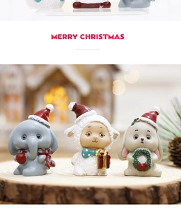 Detailed trio of miniature resin Christmas animals on wood with festive bokeh background