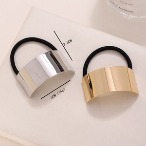 Sleek gold and silver brushed metal elastic hair ties set against a clean white background