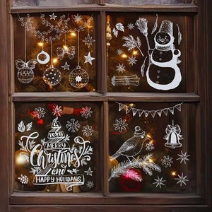 Christmas window decals with blue snowflakes and snowmen silhouettes on glass background