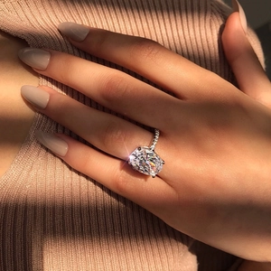 Close-up of elegant S925 sterling silver ring with large oval zircon gemstone on finger