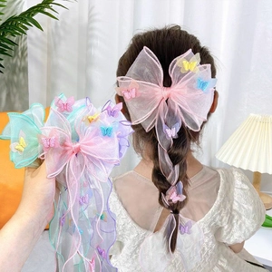 Detail of pink, blue, and purple tulle bow hair clips with long ribbons and butterflies