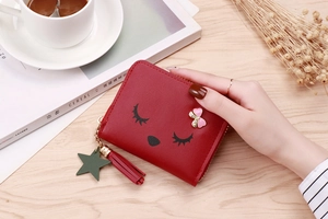 Short red faux leather purse featuring cute cartoon embroidery and tassel zipper detail