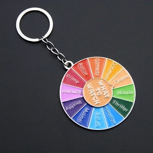 Macro view of rotating enamel movie selector keychain with colorful film genres categories