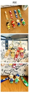 Close-up of colorful PVC football bear keychains in yellow, red, blue and green colors