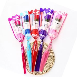 Five assorted gift sets with colorful soap roses and small plush bears in cellophane wrap