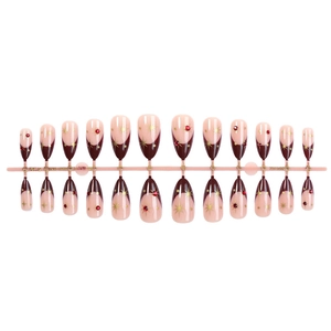 Red cat eye almond press-on nails with wine red french tips and gold star rhinestones