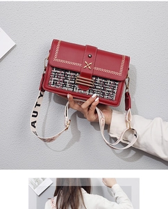 Detail of red PU leather crossbody bag with tweed panel and gold metal hardware accents