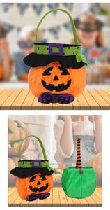 Detail of Halloween pumpkin candy bag with orange plush fabric and purple bow accent