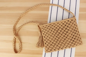 Detailed macro weave pattern and long tassels of the khaki handmade bohemian shoulder bag