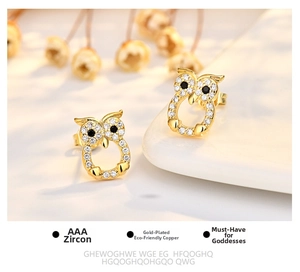Detail of owl stud earrings in gold plated copper with AAA zircon and black crystal eyes