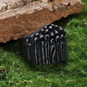 Men's gothic cross ring in vintage silver finish placed on natural forest moss