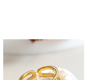 Close-up of golden geometric U-shaped heart necklace pendant with smooth finish