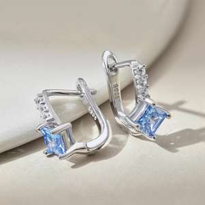 Macro shot of S925 sterling silver earrings with blue square zircon and hallmark