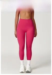 Close-up of raspberry red high-waisted yoga pants on a model for fitness shaping