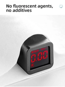 Close-up of portable detector showing zero fluorescence on white cotton bedding