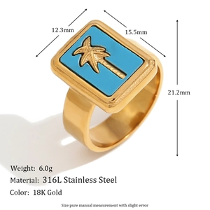 Macro view of 18K gold stainless steel ring with blue shell and coconut tree detail