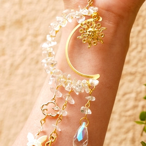 Golden moon and sun suncatcher with natural crystals and butterfly charms on wrist