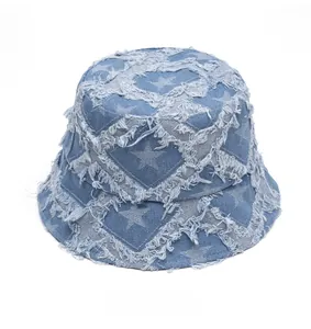 Top view of frayed star pattern denim bucket hat with distressed vintage finish texture