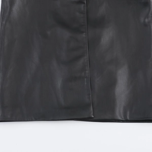 Detailed close-up of premium black PU leather texture and stitching on the coat hem