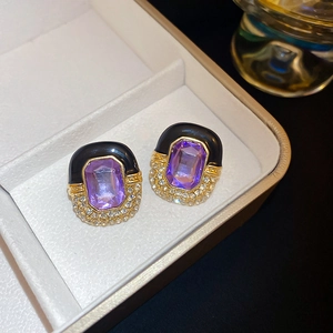 Detail of vintage round enamel earrings with purple square gemstone and micro crystal halo
